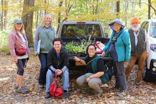 Linda Rohleder (standing to left of a truck) with volunteers at a planting workday